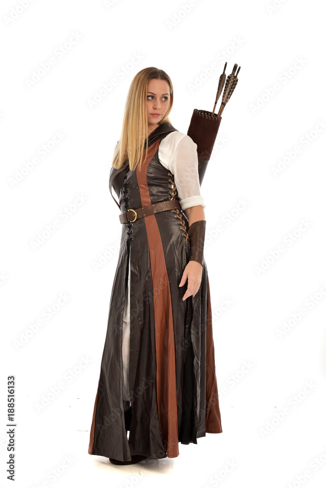 full length portrait of girl wearing brown fantasy costume, holding a bow and arrow. standing pose on white studio background. full length portrait of girl wearing brown fantasy costume, holding a bow and arrow. standing pose on white studio background.