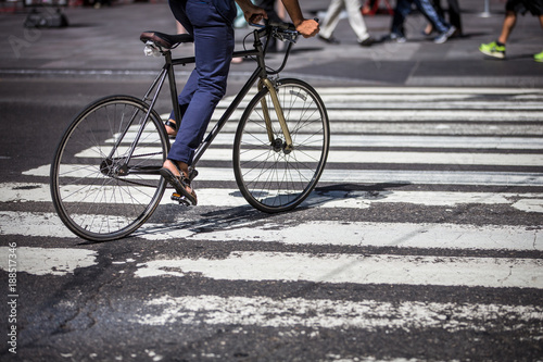 Man on a bike on a crossing in Manhattan, NYC
