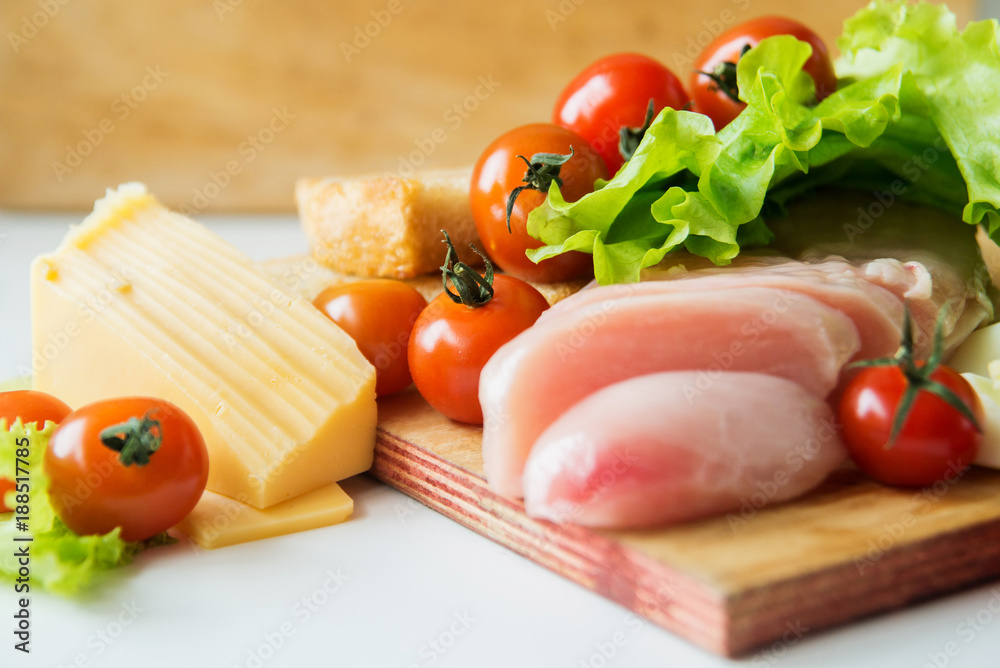 caesar salad and ingredients at table background