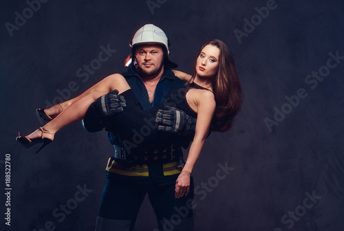 Fireman holds saved woman. © Fxquadro