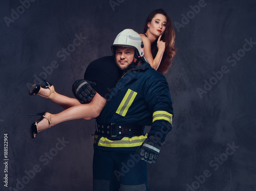 Firefighter holds a woman.