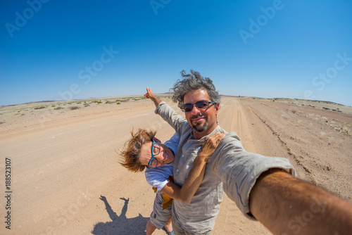 Adult couple taking selfie in the Namib desert, Namib Naukluft National Park, main travel destination in Namibia, Africa.