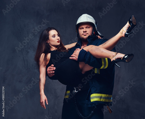 Fototapeta Naklejka Na Ścianę i Meble -  Fireman holds saved woman.