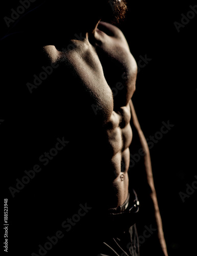 Silhouette of sexy man's body with naked chest