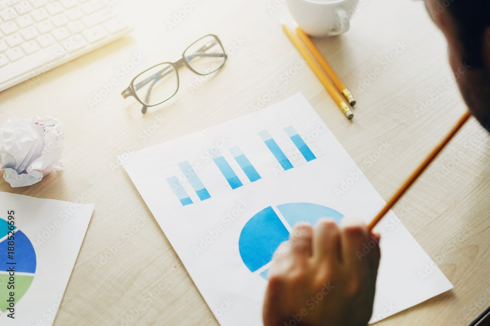 Man analyzes the data and graphs. Business Analysis , Strategy concept Man analyzes the data and graphs. Business Analysis , Strategy concept