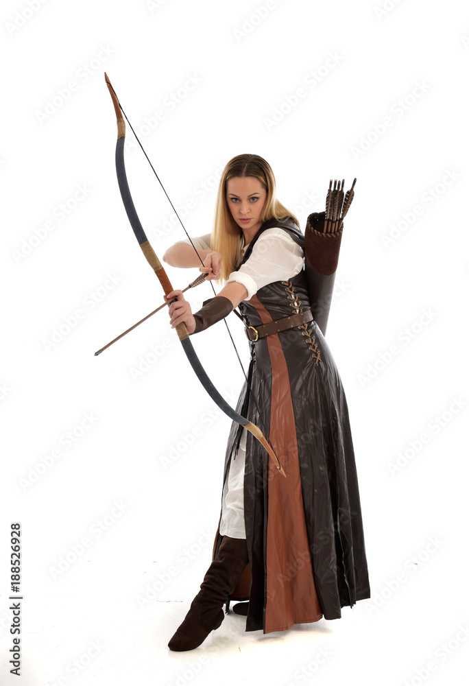 full length portrait of girl wearing brown fantasy costume, holding a bow and arrow, on white studio background. full length portrait of girl wearing brown fantasy costume, holding a bow and arrow, on white studio background.
