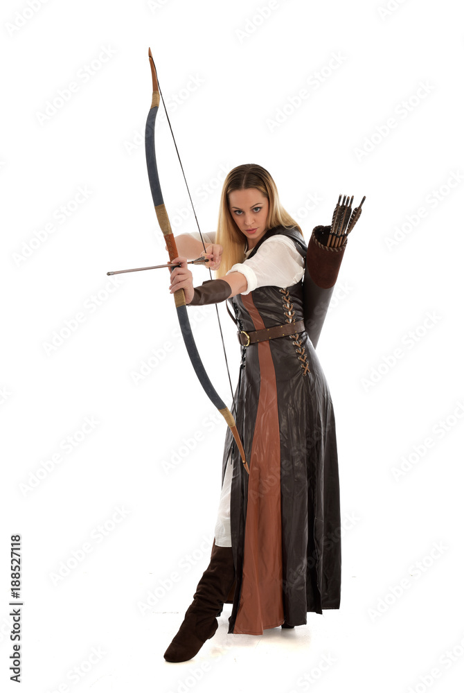 full length portrait of girl wearing brown fantasy costume, holding a bow and arrow, on white studio background. full length portrait of girl wearing brown fantasy costume, holding a bow and arrow, on white studio background.