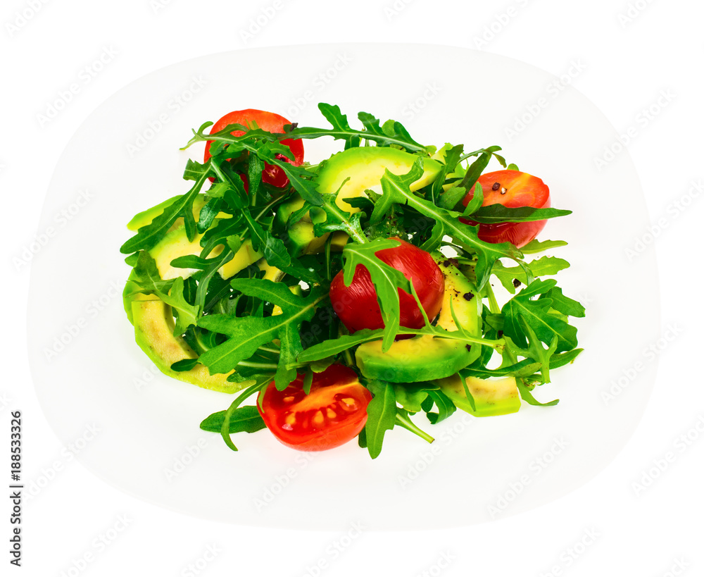 Vitamin vegetarian salad from arugula and avocado on white plate Vitamin vegetarian salad from arugula and avocado on white plate