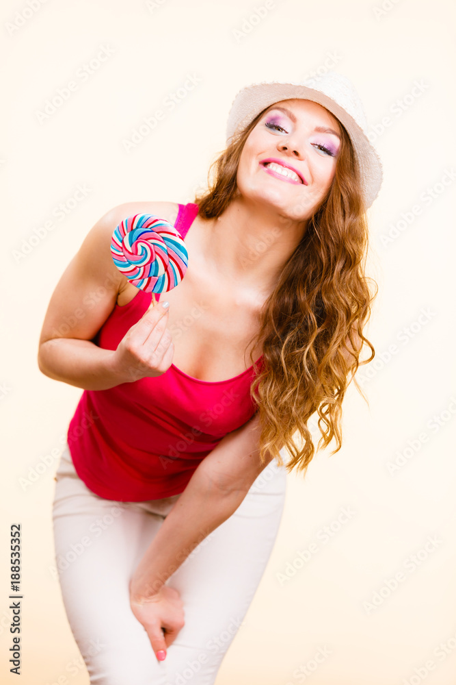 Woman holds colorful lollipop candy in hand Woman holds colorful lollipop candy in hand