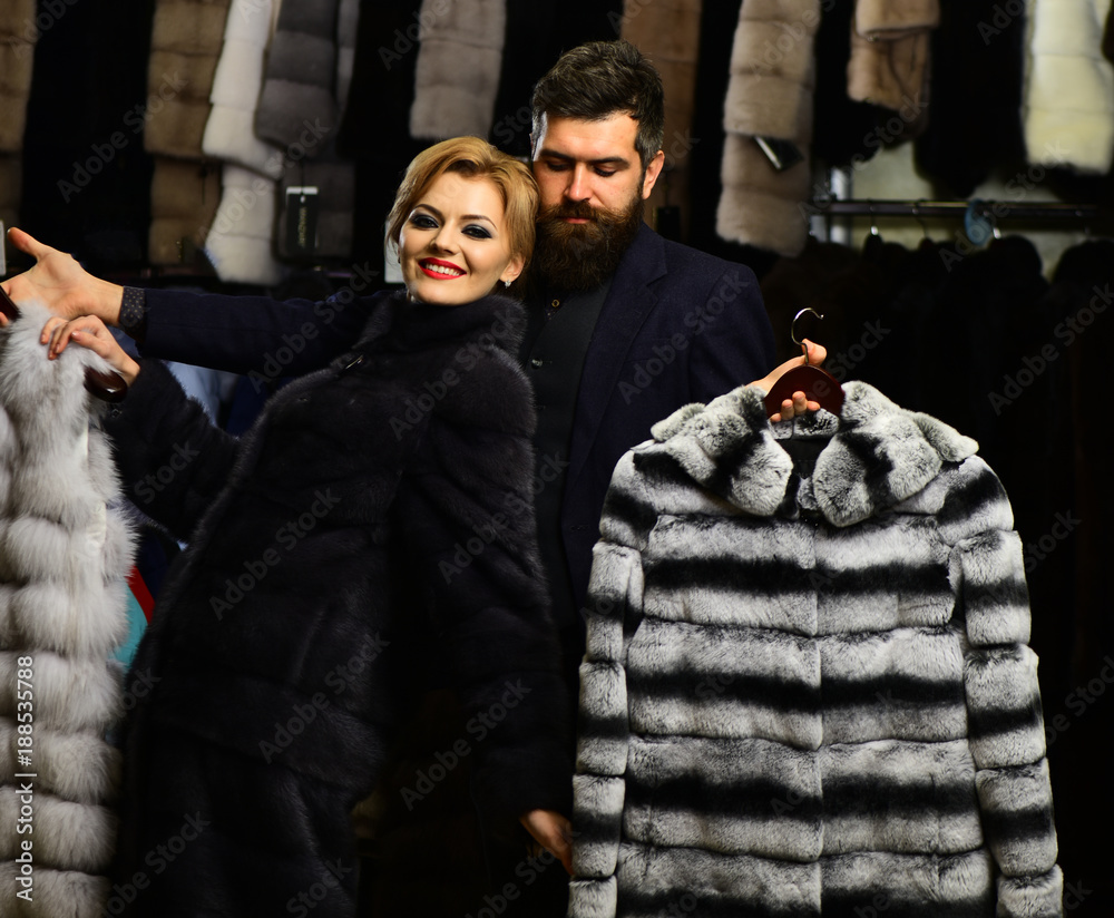 Customer with beard and woman buy furry coat.