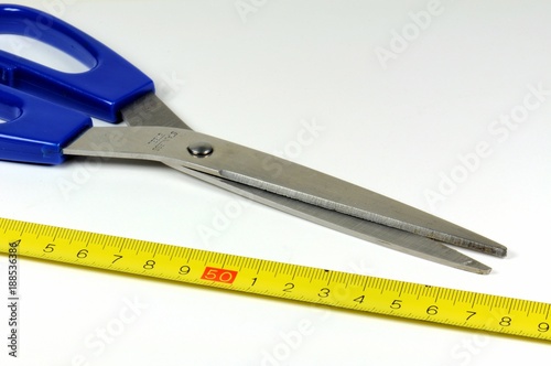 Group of tools. Tape measure in decimal system and scissors. On white background.