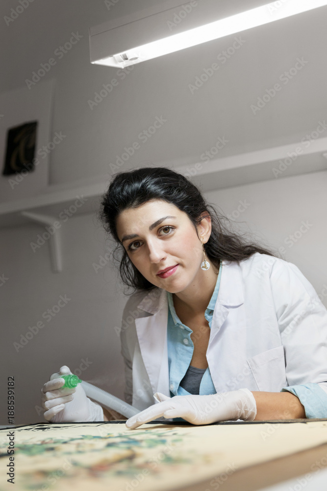 Woman in protective white gloves working in laboratory Woman in protective white gloves working in laboratory