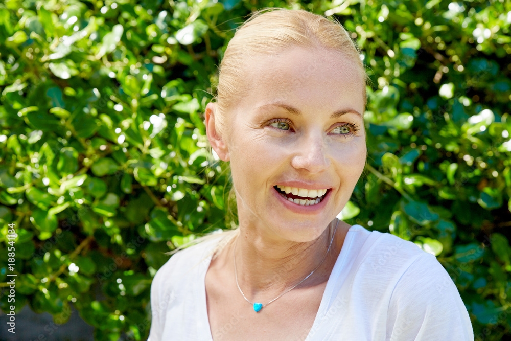 Portrait of happy blond woman outdoors