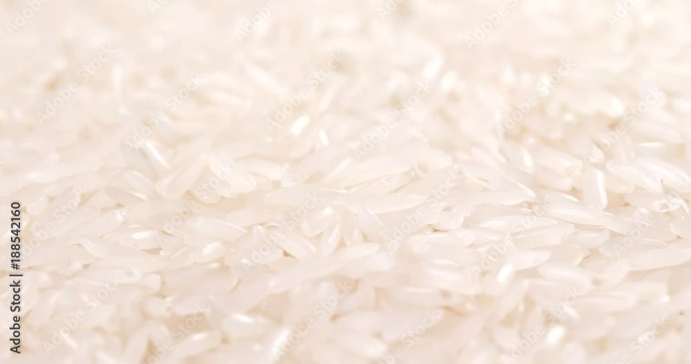 Uncooked white rice in rotation Uncooked white rice in rotation