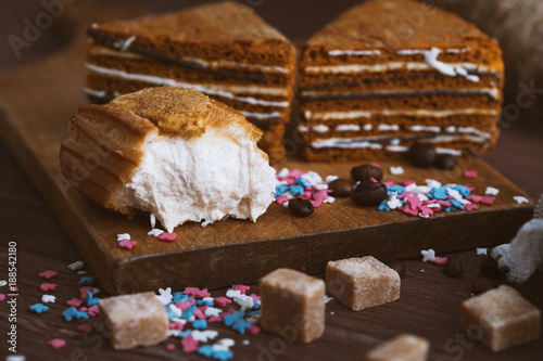 three tender cake with coffee beans and bright powder on a gray wooden background. Selective focus, close up. background for postcard. photo