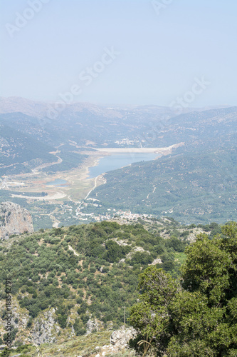 Green and blue landscape with a lake, green trees and mountains in Crete (Greece)