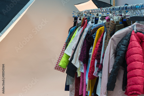Different clothes on hangers in the photostudio