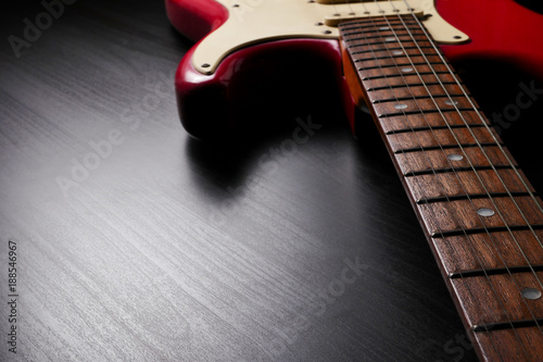 Close up of Electric guitar body and neck detail on black background.