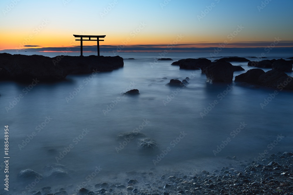 trii - gateway of shrine in the sea in the early morning by long exposure