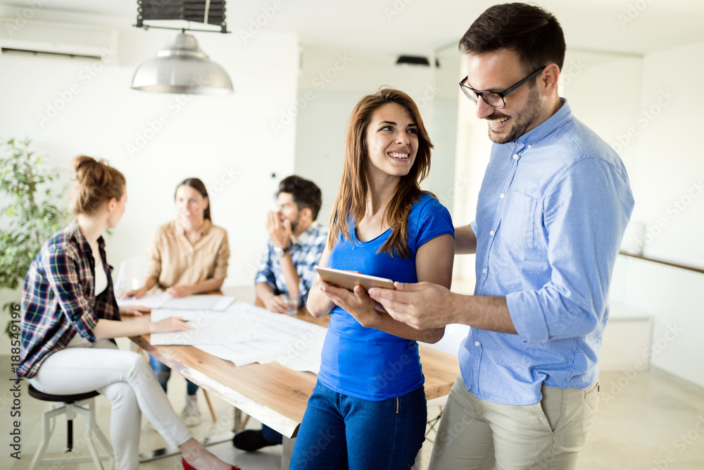 Image of business partners discussing documents and ideas