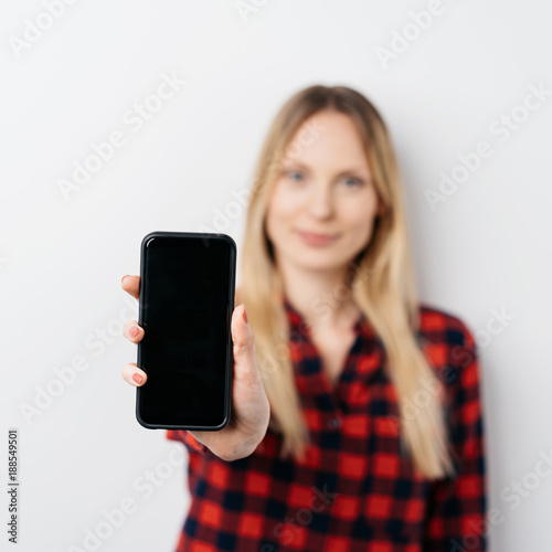 Woman extending a blank mobile phone