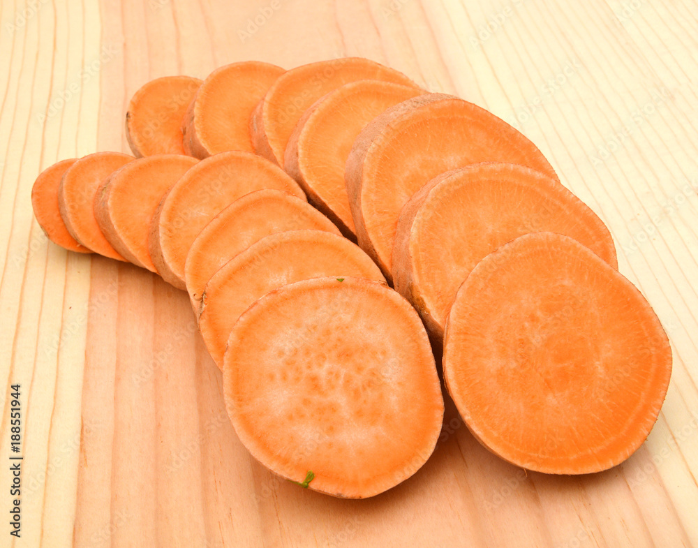 Fresh Organic Orange Sweet Potato against a background Fresh Organic Orange Sweet Potato against a background
