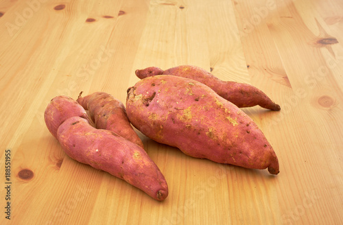 Sweet potatoes on a rustic wooden table