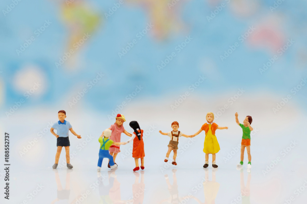 Miniature people, family and children with colorful balloons standing in front of house, Family concept.