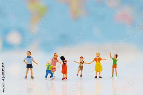 Miniature people, family and children with colorful balloons standing in front of house, Family concept. © Rattana.R
