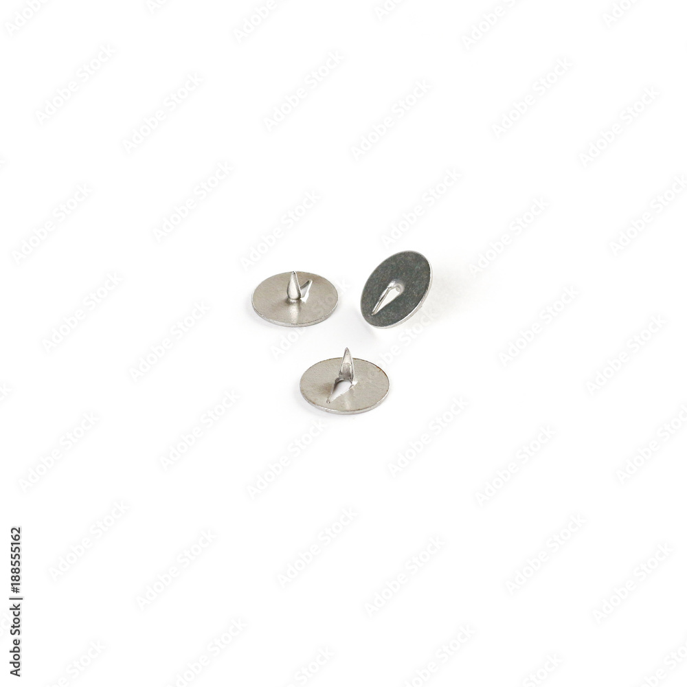 Metal pushpin on a white background. Closeup