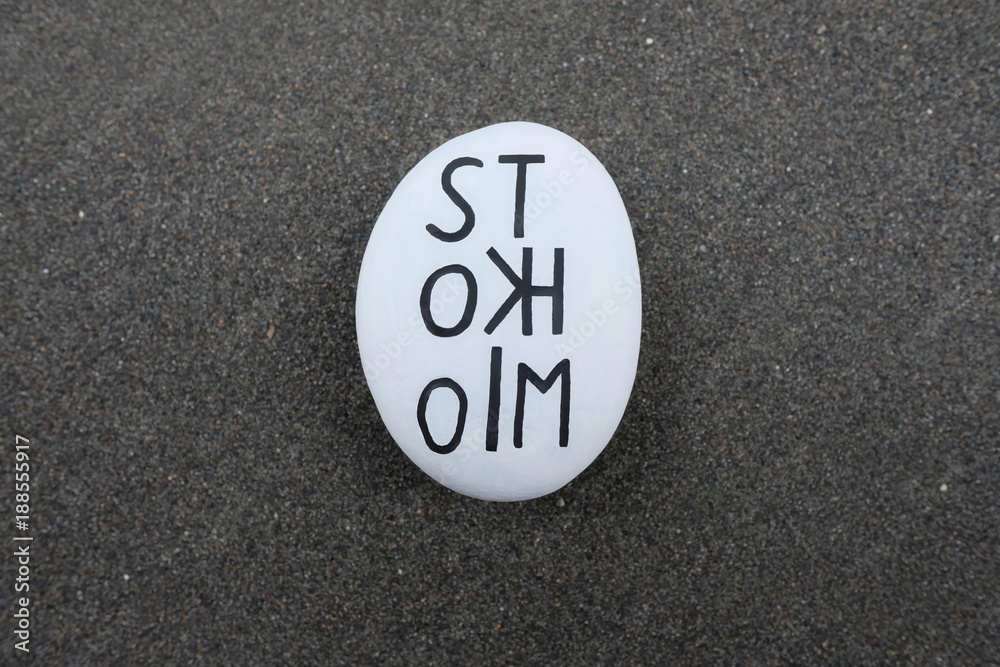 Stockholm text carved on a stone over black volcanic sand Stockholm text carved on a stone over black volcanic sand