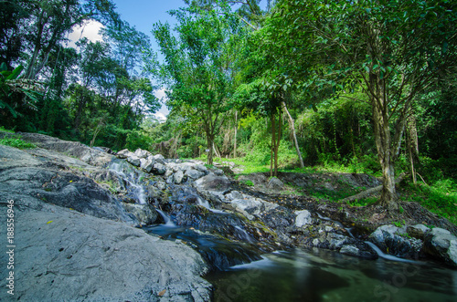 A small little waterfall falling on a small lake in Thailand