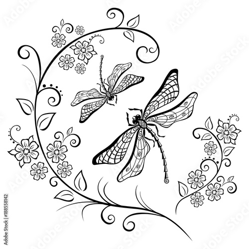 Silhouette of a dragonfly and flowering branches.