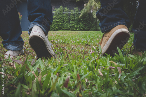 boyfriend & girlfriend dating in valentine's day. feet of man & woman in love walking together outdoor. relationship, couple, lifestyle concept