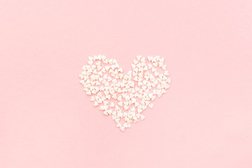 Valentine's Day composition. Heart on pale pink background. Flat lay, top view Love concept.