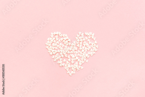 Valentine's Day composition. Heart on pale pink background. Flat lay, top view Love concept.