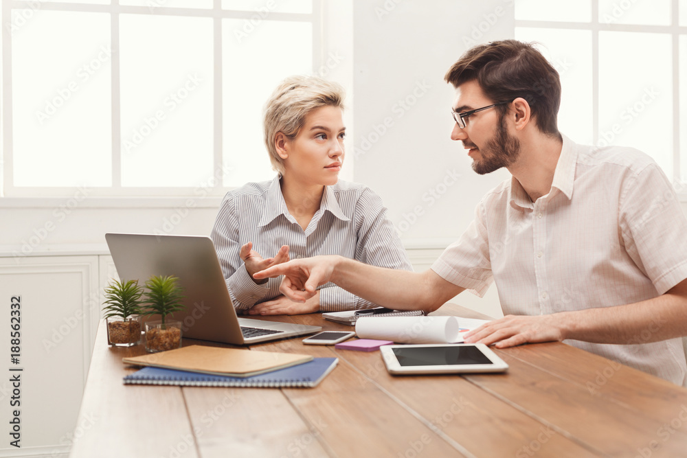 Couple of young business partners working at modern office Couple of young business partners working at modern office
