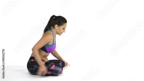 Young attractive woman practicing yoga doing Padma Mayurasana, Peacock Pose in full length, isolated over white studio background