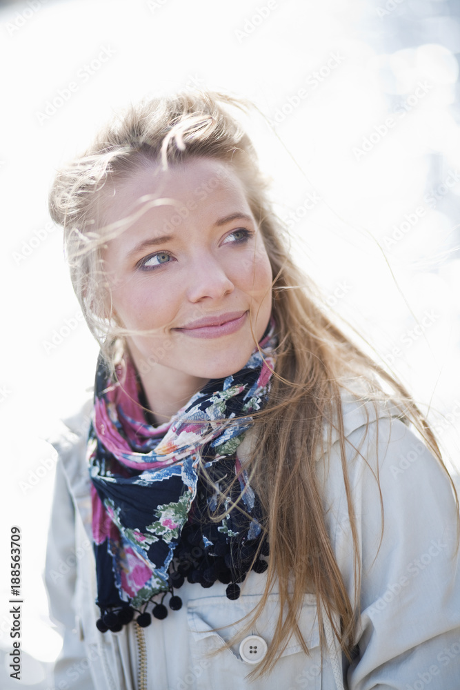 Portrait of young blonde woman with floral scarf looking at right side Portrait of young blonde woman with floral scarf looking at right side