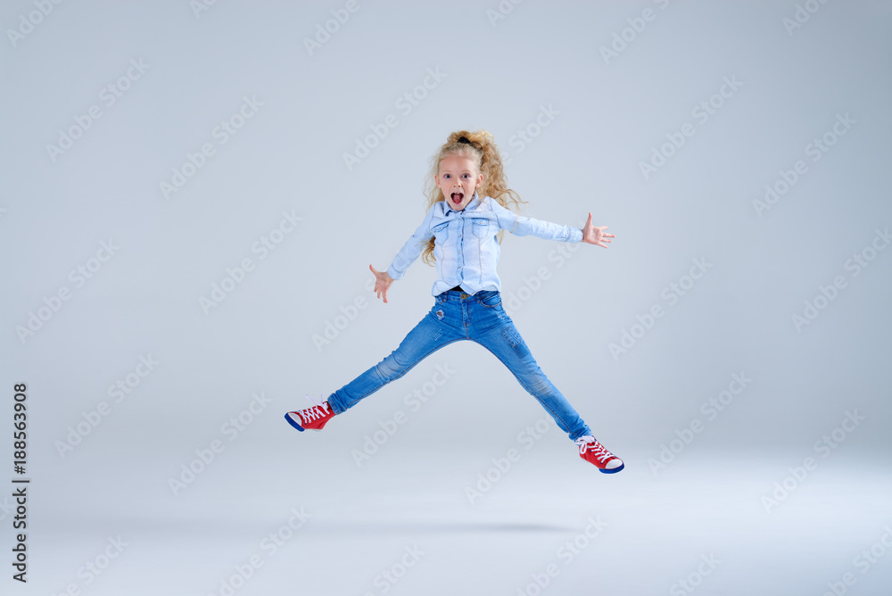 Laughing joyful girl jumping with outstretched hand Laughing joyful girl jumping with outstretched hand