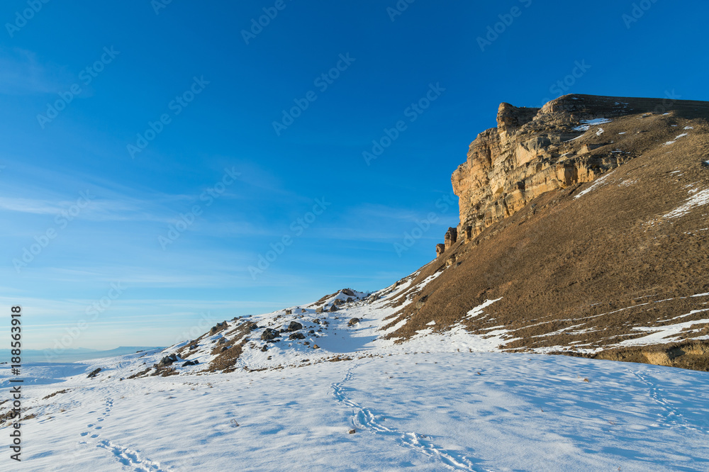 The landscape of snow-covered Caucasian rocks on the Gumbashi Pass.
