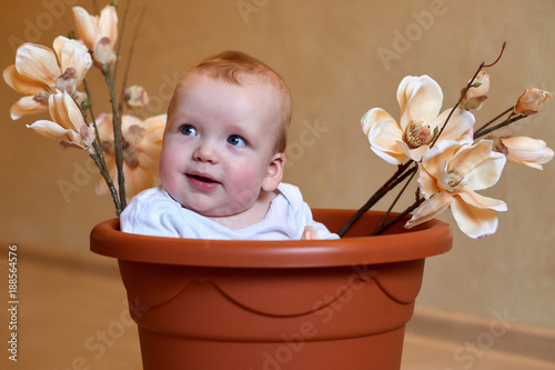 Little boy in a plastic bucket