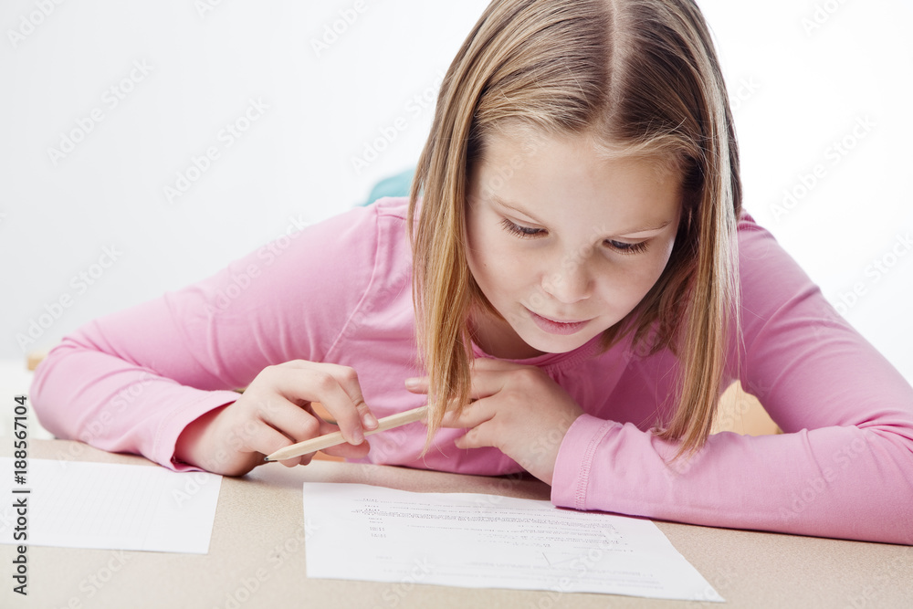 Girl concentrates on test in class Girl concentrates on test in class