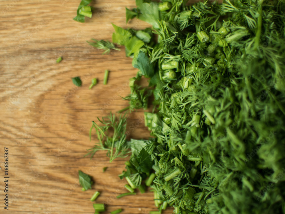 finely chopped greens on a chopping board. finely chopped greens on a chopping board.