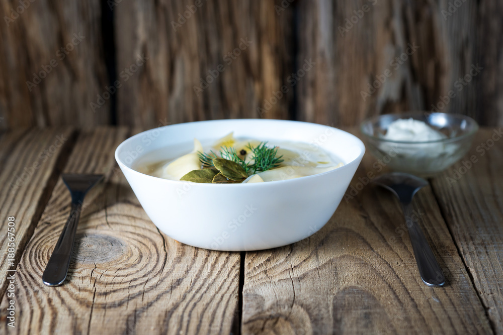 dumplings with broth in the bowl on wooden background dumplings with broth in the bowl on wooden background