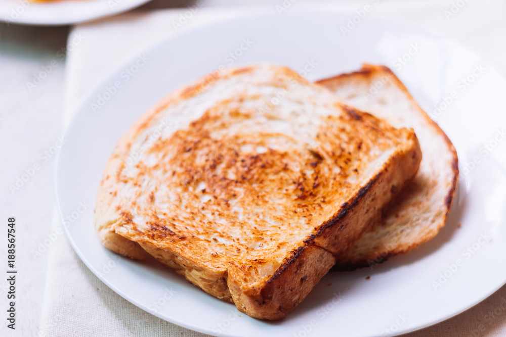 Toast bread on white plate.