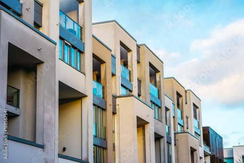 modern white square townhouses with big blue windows