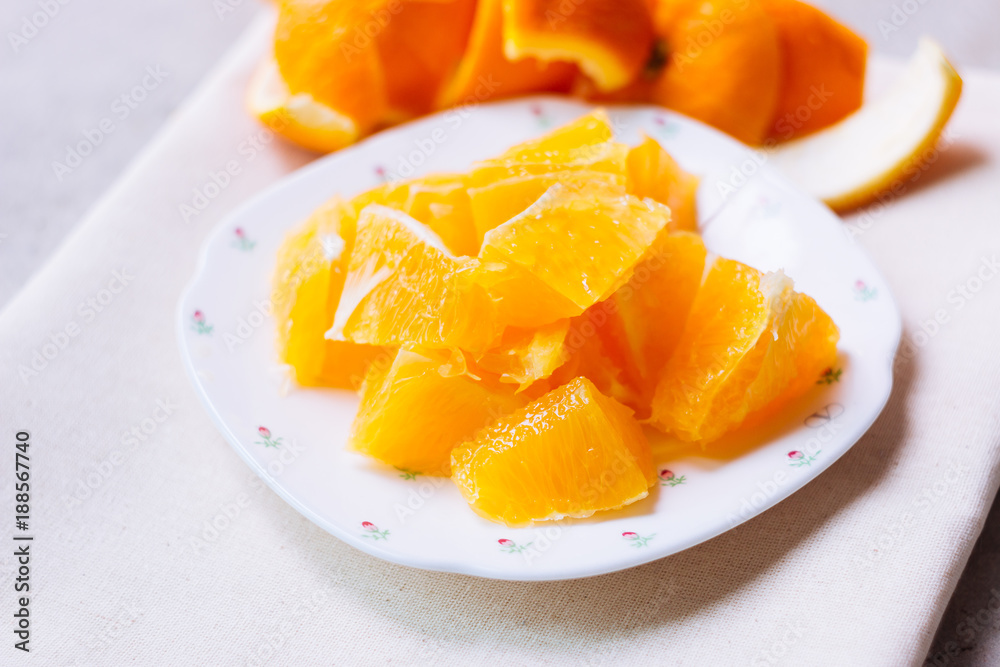 Orange sliced in white plate Orange sliced in white plate