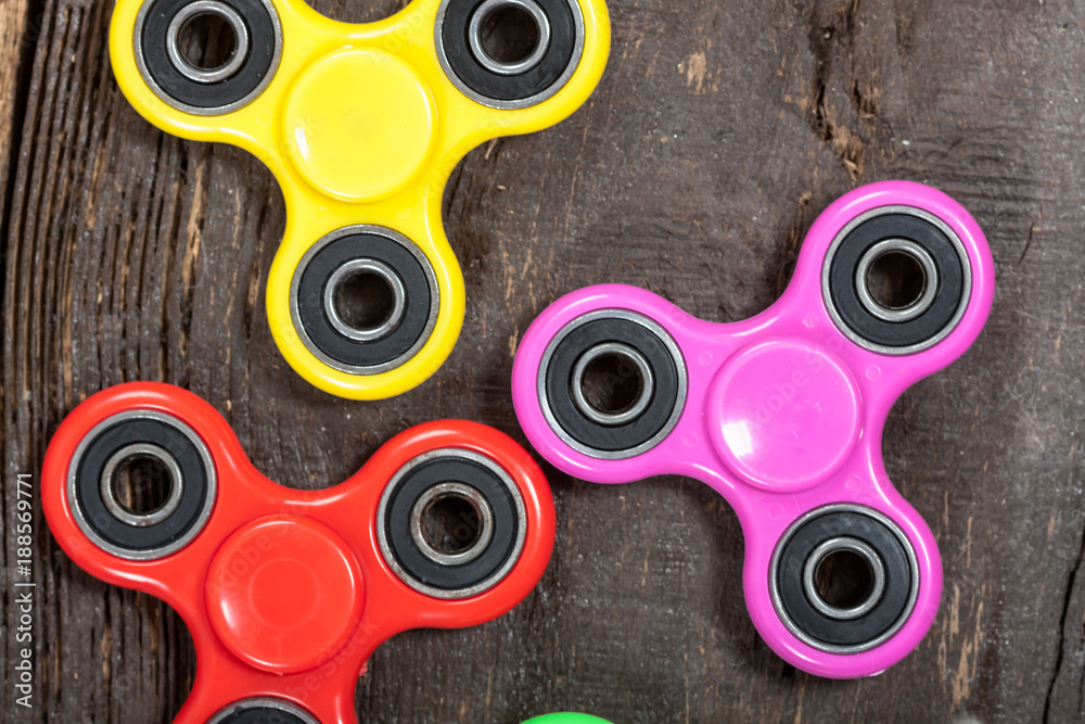 Group of spinners on wooden table