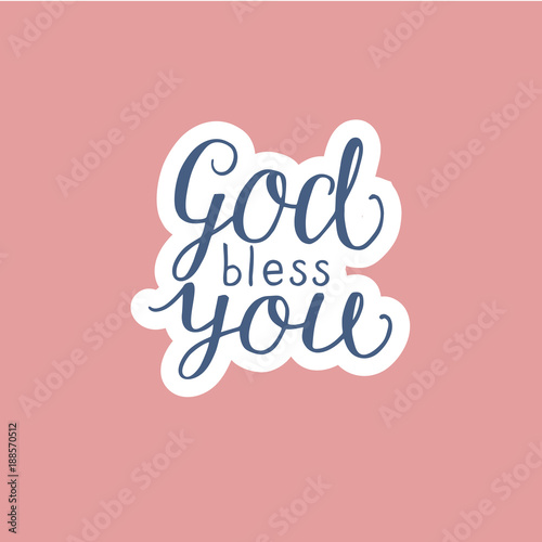 Hand lettering God bless you made on pink background.